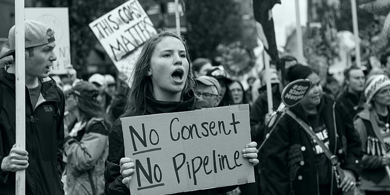 800px-Protester_holding_sign_stating_No_Pipeline,_No_Consent,_during_a_Kinder_Morgan_Pipeline_Rally_on_September_9th,_2017_in_Vancouver,_Canada.jpg